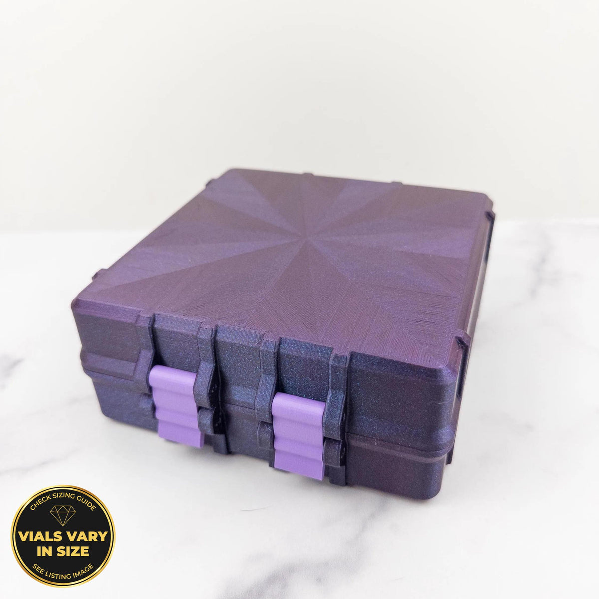 A purple, square-shaped container with a starburst pattern on its lid, sitting on a white marble surface.