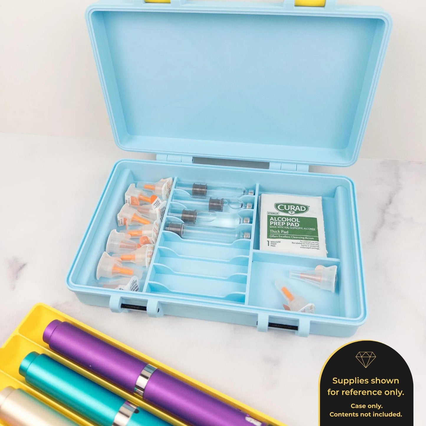 A blue plastic container with compartments holding various items, including what appear to be pens and other small objects, placed on a marble surface.