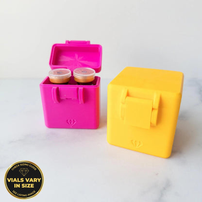 two colorful plastic containers, one pink and one yellow, placed on a white marble surface.