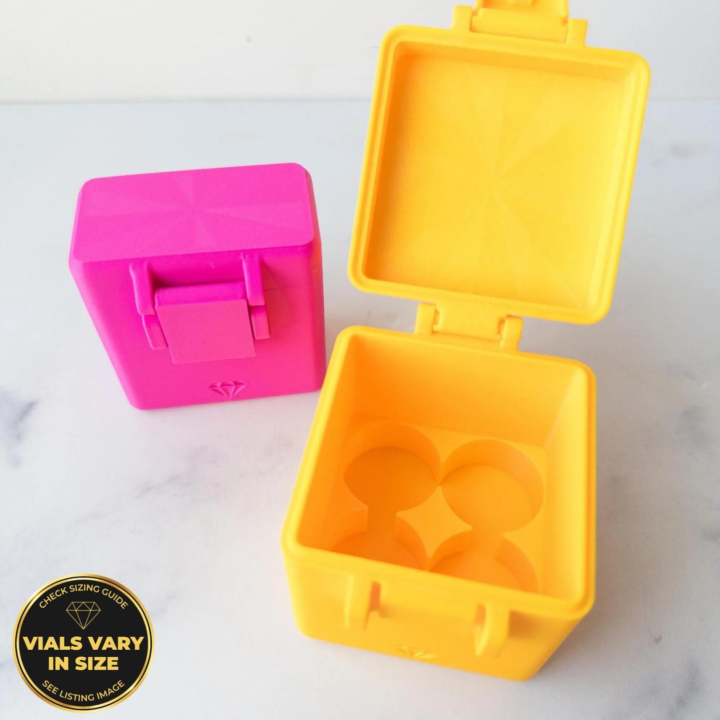 two colorful plastic containers, one pink and one yellow, placed on a white surface.