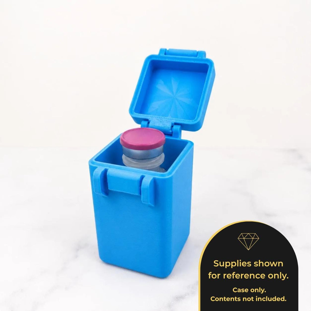 A blue plastic container with a pink lid is shown, with the lid open and a small object inside.